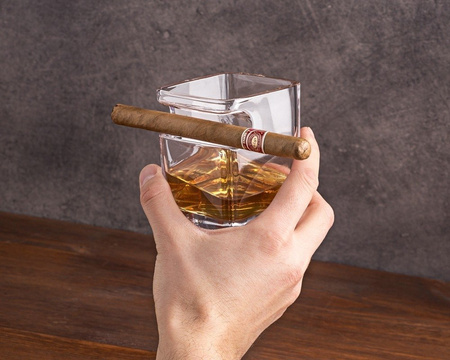 Whisky cigar holding glass