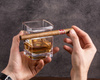 Whisky cigar holding glass